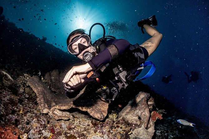 Female diver around corals