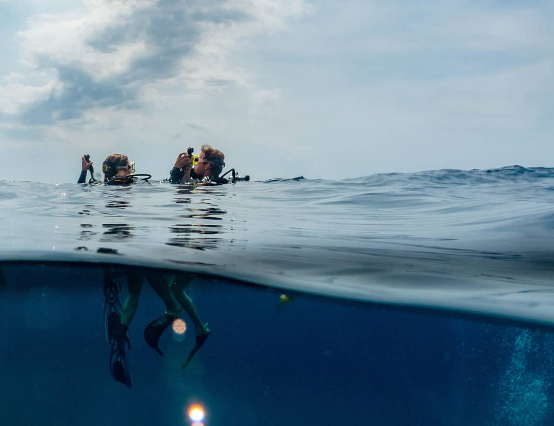 Two divers about to descend